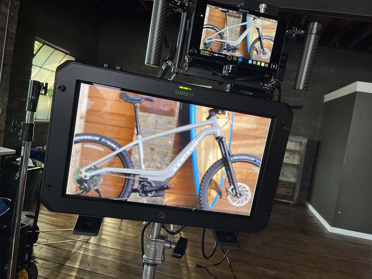 A closeup view of the camera filming the bikes on the set of the Serial-1 video shoot.